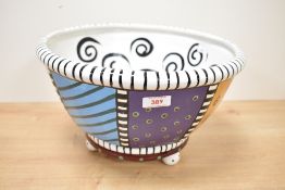 A large contemporary Studio DesignWorks pottery bowl with hand-painted multicolour decoration of