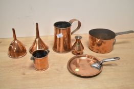 A collection of early 20th-century copperware, to include a small pot, cream can, two funnels, a