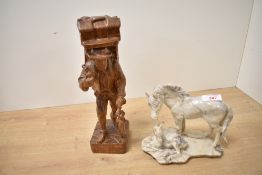 A 20th-century Folk Art-style hand-carved wooden figurine, depicting a male figure in traditional