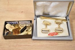 A small collection of cufflinks, including a cufflink and tie clip set, a pair having Japanese