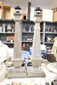 A set of two modern imitation-wood lamp bases, of architectural square column form, with long plugs,