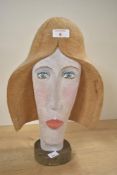 A 20th-century D.I. Griffith Folk Art wooden bust of a female, titled 'Bridget', with stylised