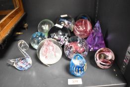 A selection of 20th-century studio art glass paperweights, to include two Caithness examples —