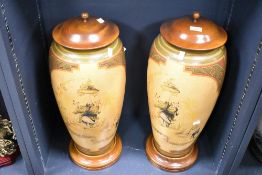 A pair of large 20th-century Oriental porcelain vases with wooden lids, featuring hand-painted