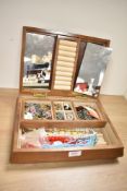 A large wooden jewellery box, containing an assortment of costume jewellery including beaded