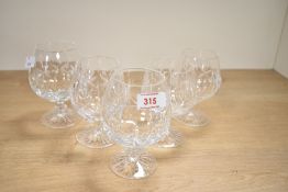 A selection of five Waterford Kylemore-style cut crystal brandy glasses, featuring wide, rounded