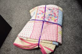 A 1990s-2000s quilt, 100% cotton, padded and stuffed, having a colourful printed patchwork design