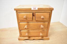 A small 20th-century pine tabletop chest of drawers, possibly an apprentice piece, having two