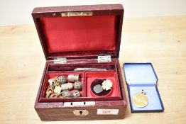 Two faux leather jewellery boxes, one of red crocodile and one of green, containing a small