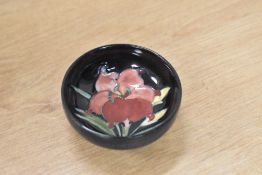A mid-20th century Moorcroft pottery Hibiscus pattern dish, characterised by a delicately hand-