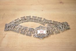 A silver plated nurses belt, the large central buckle of a pierced scroll design flanked by