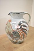 A late 20th-century Colin Kellam studio pottery stoneware rooster jug, featuring two roosters with