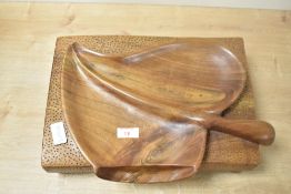 A mid 20th-century to modern hand-carved monkey pod wood leaf-shaped dish, comprising two separate