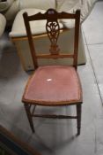 A Victorian bedroom chair having overstuffed seat and turned frame