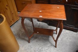 A late Victorian mahogany occasional table having rectangular top and undertier , on shaped frame,