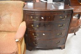 An early 20th Century reproduction chest , in the Georgian style with bow front and bracket feet,