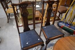 A set of four early 20th Century stained frame dining chairs having drop in seats