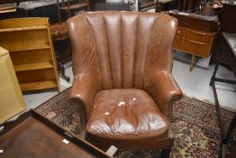 A modern Tetrad wing back armchair in brown leather, width approx. 70cm