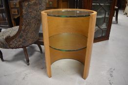 A modern designer oak finish bedside table, in the Tom Schneider Saturn lamp table style, having