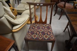 A set of vintage six teak G plan style dining chairs having drop in seats and stylised rail backs