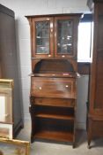 An Edwardian mahogany slender bureau having inlaid decoration, and leaded and part glazed doors to