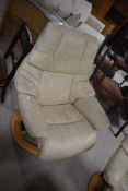 A modern Stressless swivel recliner armchair , in cream leather on beech frame