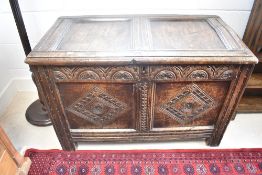 A period oak kist of compact sized with carved frieze and double panel, dimensions approx. W102
