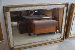 A modern wall mirror having marble effect and gilt surround, approx. 107 x 78cm