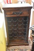 A modern hardwood and metal 24 bottle wine rack having drawer to top, dimensions approx. H102 W56