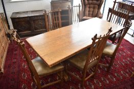 A traditional golden oak dining suite in the Arts & Crafts style comprising refectory table and