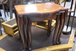 A modern hardwood nest of three tables