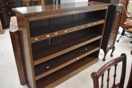 A set of early 20th Century mahogany library shelves, having hinged flaps to shelves, dimensions