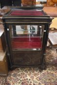 A Victorian ebonised display cabinet/vitrine having bijouterie section over part glazed cabinet