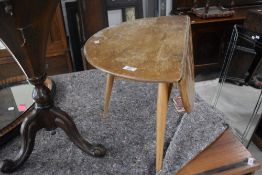 A vintage Ercol coffee table having single gateleg (evidence of historical worm), width approx.