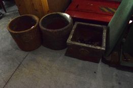 Three rustic planters of distressed metallic form , two being circular and one square