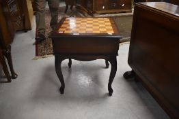 A reproduction mahogany games table having chequers board top, approx. 51 x 51cm
