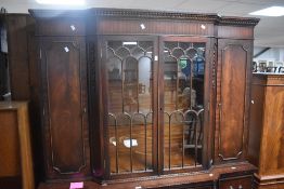 A reproduction mahogany breakfront bookcase, dimensions approx H192 W143cm