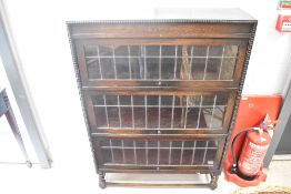 An early 20th Century oak bookcase , not stacking , three shelves with lift up leaded glass doors,