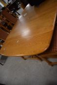 A modern light Ercol extending dining table (probably Colonial range) and a set of similar dining