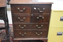 A Regency revival side cabinet having faux drawers to upper cupboard section over two long drawers