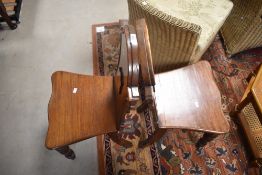 A pair of 19th Century mahogany hall chairs having shaped shield backs