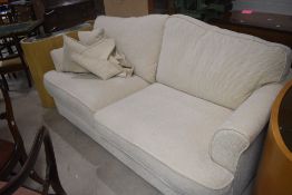 A modern cream two/three seater settee in cream (ex stollers), width approx. 183cm
