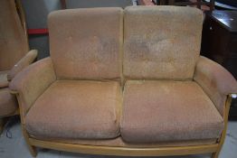A modern Ercol three piece lounge suite comprising two settees and electric recliner chair, on