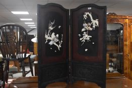 An Oriental bi fold fire screen in the Shibayama style having bird relief decoration in bone and