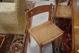 A set of six vintage teak and seagrass dining chairs having ply backs