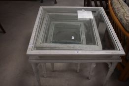 A modern shabby chic style nest of three glass top table, largest being approx 69 x 69 (height