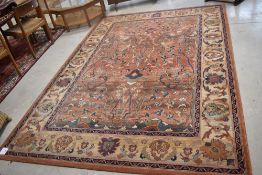 A modern Belgian carpet , having russet ground and naturalistic design, label Kennedy Carpets ,