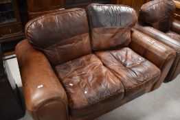 A modern brown leather two seater settee and armchair