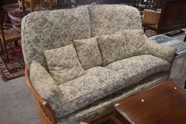 A modern Ercol cottage suite comprising settee and armchair , having beech or elm frame with