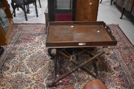A Victorian oak butlers tray on turned frame